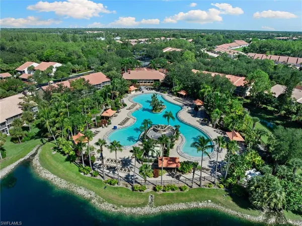 an aerial view of a house with a garden and lake view