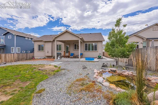 a front view of a house with a yard and outdoor seating