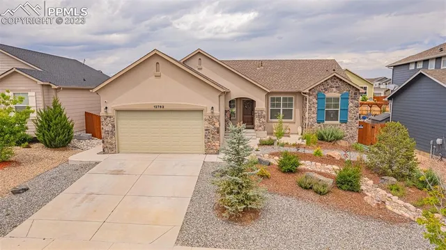 a view of a house with a yard and plants