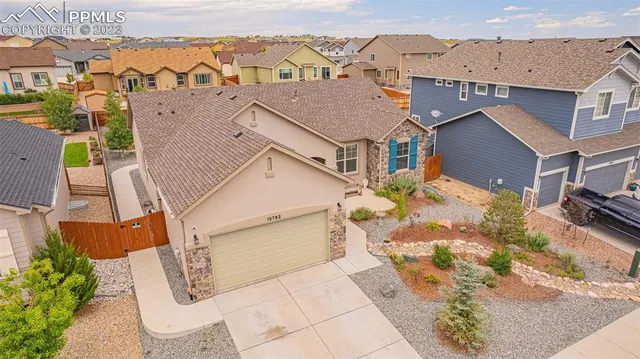 an aerial view of a house with a yard