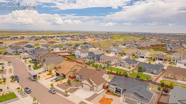an aerial view of residential building with yard