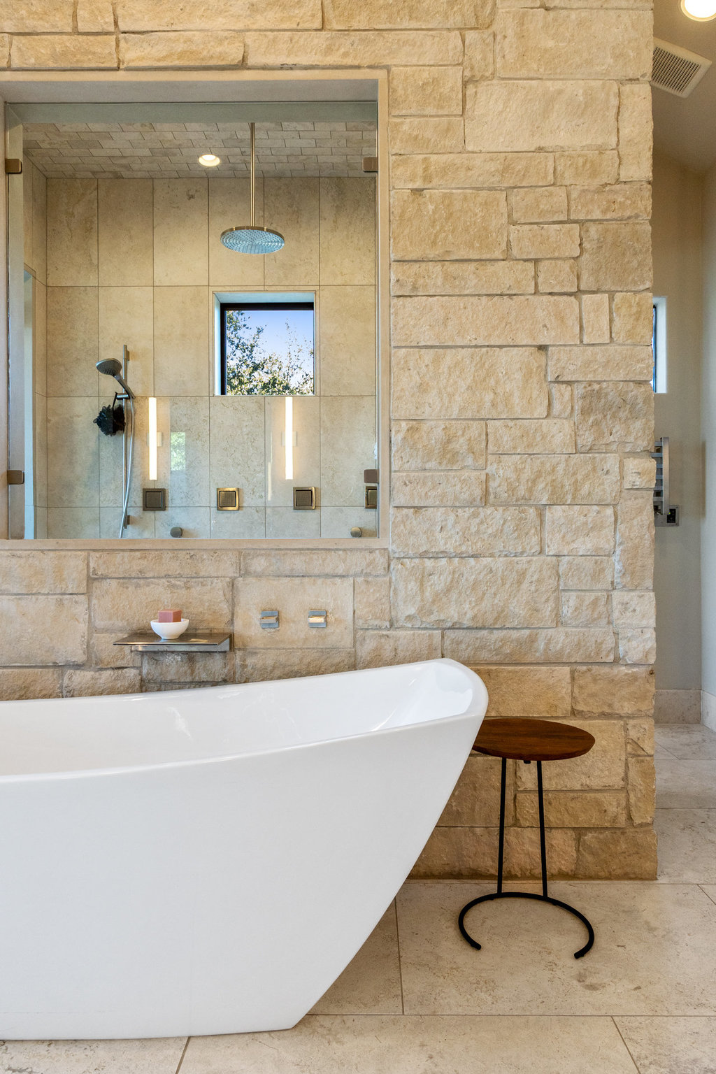 3550 Bell Springs Road Dripping Springs, TX 78620 - Photo 24 of 40 Bathroom with walk in shower, recessed lighting, a freestanding tub, and tile walls