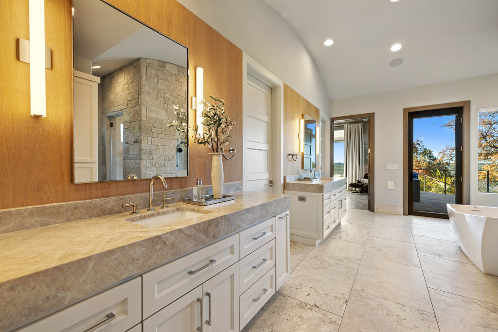 3550 Bell Springs Road Dripping Springs, TX 78620 - Photo 25 of 40 Bathroom featuring a freestanding bath, two vanities, tiled shower, vaulted ceiling, and recessed lighting