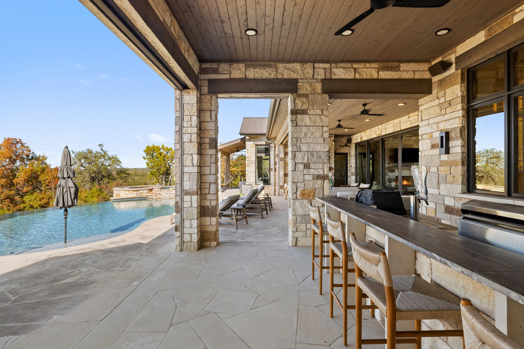 3550 Bell Springs Road Dripping Springs, TX 78620 - Photo 36 of 40 View of patio / terrace featuring a ceiling fan and a pool with connected hot tub