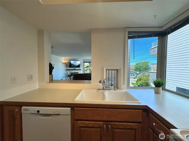 a kitchen with a sink and a large window