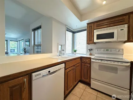 a kitchen with stainless steel appliances granite countertop a sink and a microwave