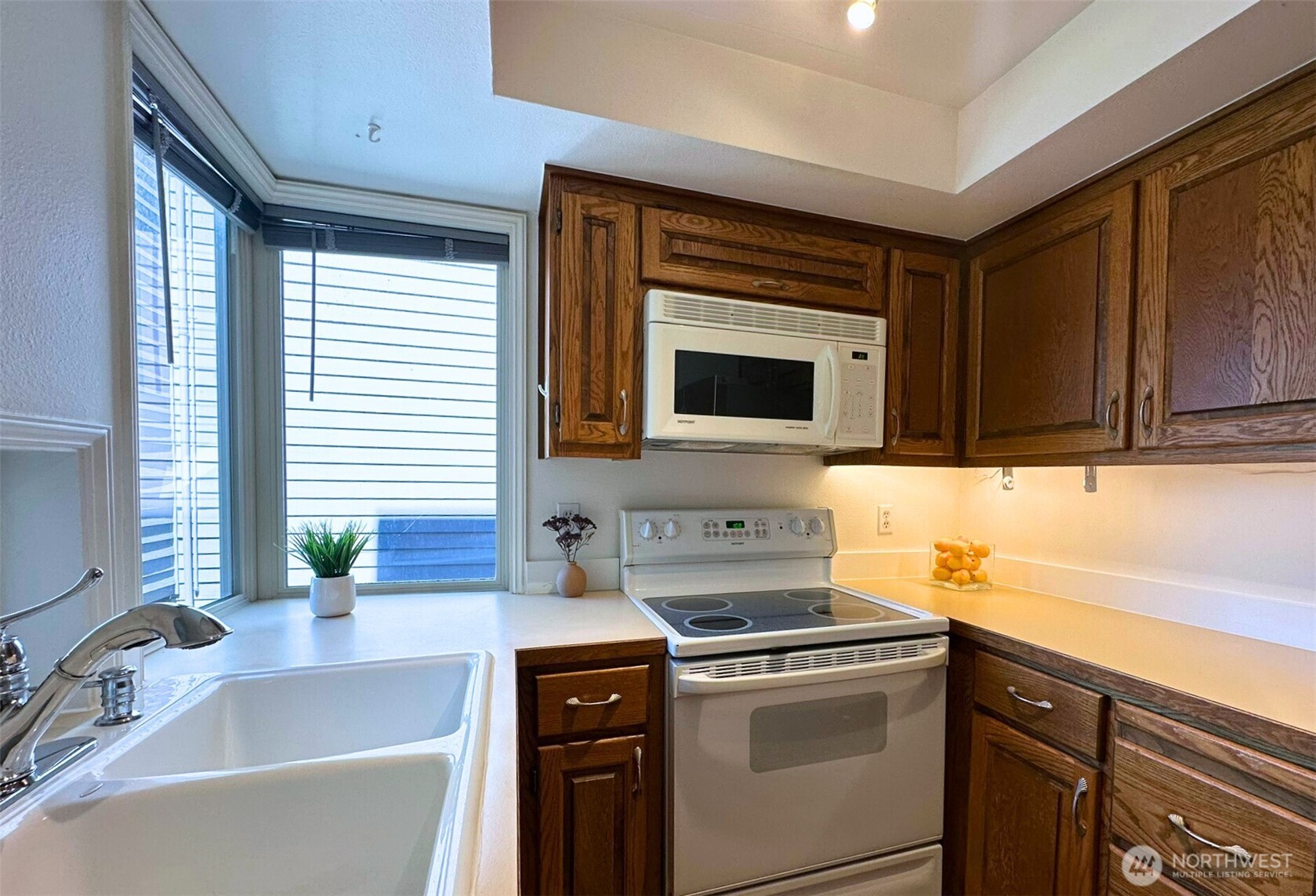 3204 Alki Avenue Southwest, Unit 1 Seattle, WA 98116 - Photo 16 of 35 a kitchen with stainless steel appliances a stove a sink and a microwave