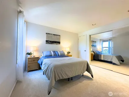 a spacious bedroom with a bed and a couch