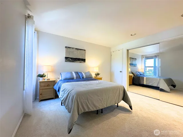 a spacious bedroom with a bed and a couch