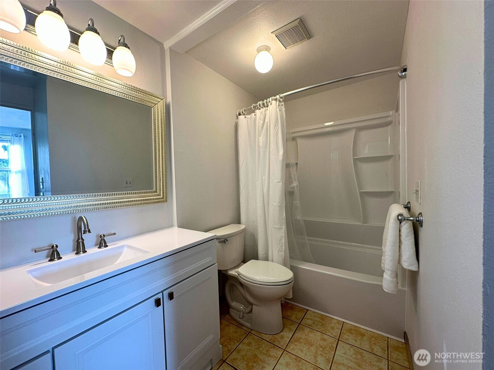 3204 Alki Avenue Southwest, Unit 1 Seattle, WA 98116 - Photo 20 of 35 a bathroom with a sink a toilet and shower