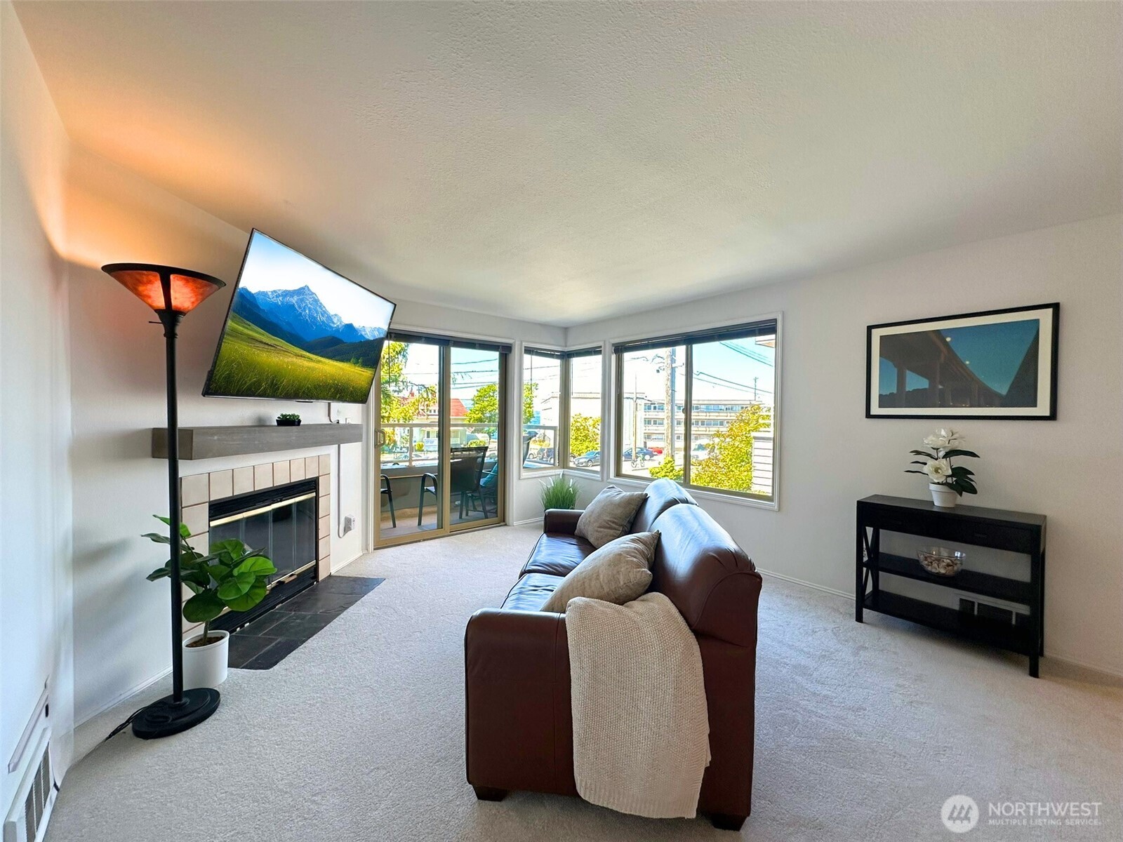 3204 Alki Avenue Southwest, Unit 1 Seattle, WA 98116 - Photo 6 of 35 a living room with furniture a fireplace and a flat screen tv