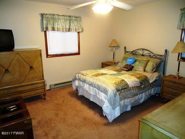 2328 Brookfield Road Lake Ariel, PA 18436 - Photo 12 of 35 a bed sitting in a bedroom next to a window
