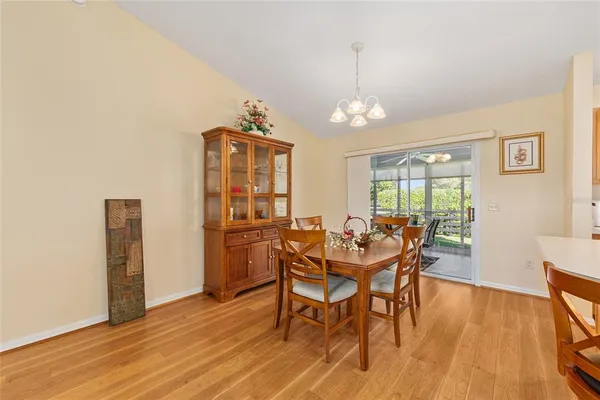 a view of a dining room with furniture and a chandelier