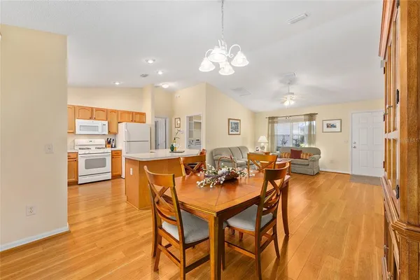 a dining room with furniture and wooden floor