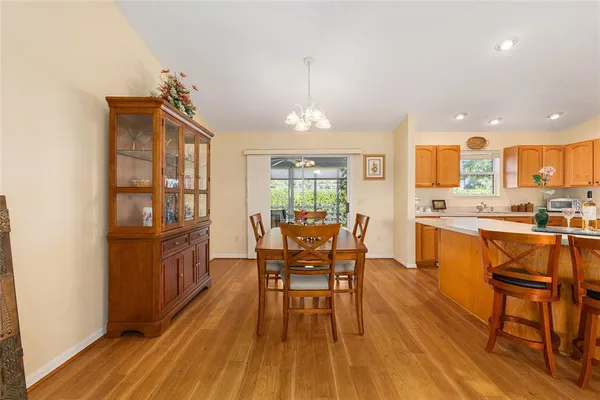 a kitchen with stainless steel appliances kitchen island granite countertop a sink refrigerator and cabinets