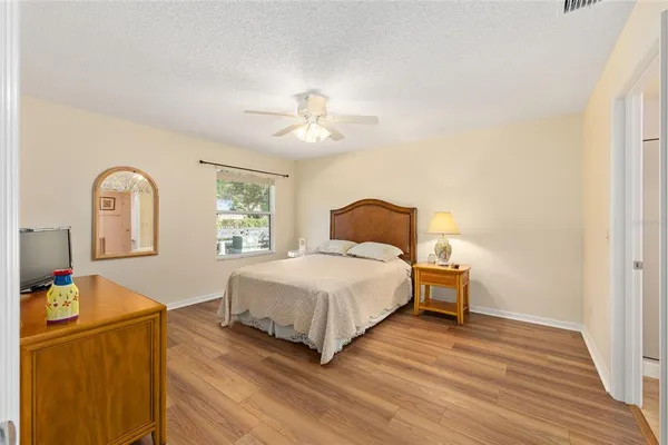 a bedroom with a bed and a chandelier