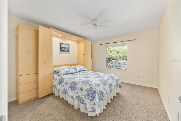 a dining room with furniture a chandelier and glass door
