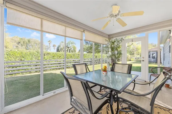 a dining room with furniture a chandelier and wooden floor