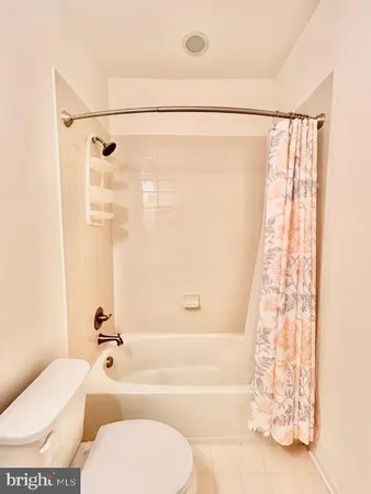 a bathroom with a toilet and a bathtub