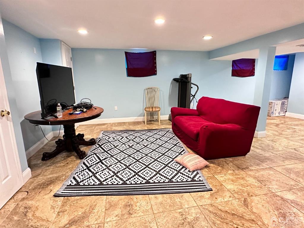 1722 Holly Road North Brunswick, NJ 08902 - Photo 11 of 22 a living room with furniture and a flat screen tv