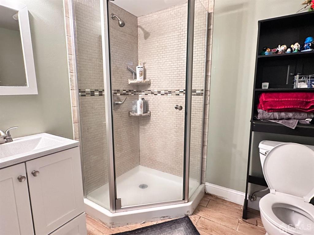 1722 Holly Road North Brunswick, NJ 08902 - Photo 13 of 22 a bathroom with a shower a toilet and a sink
