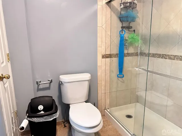 a white toilet sitting next to a bathroom sink