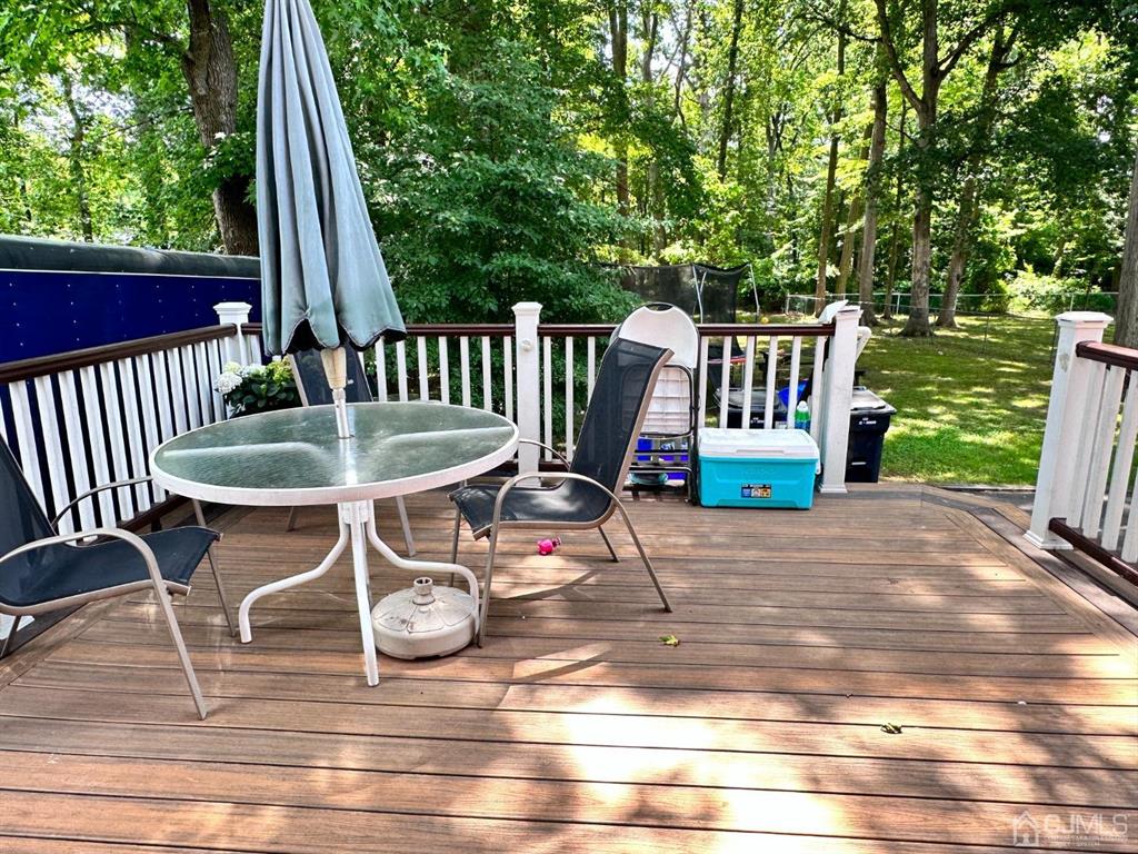1722 Holly Road North Brunswick, NJ 08902 - Photo 16 of 22 a backyard of a house with table and chairs