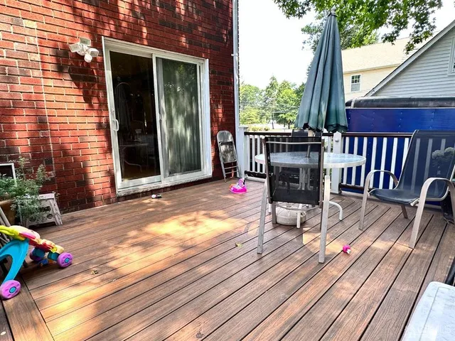 a view of a deck with wooden floor and outdoor seating