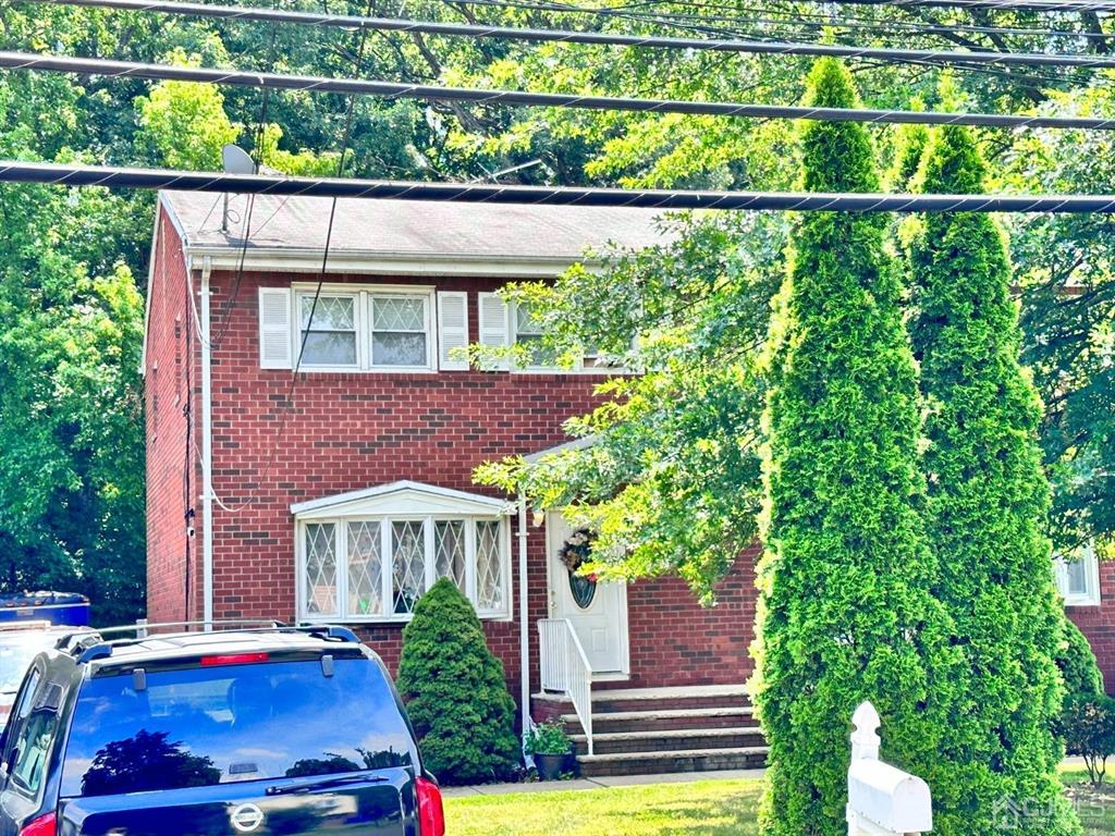 1722 Holly Road North Brunswick, NJ 08902 - Photo 21 of 22 a front view of a house with a yard