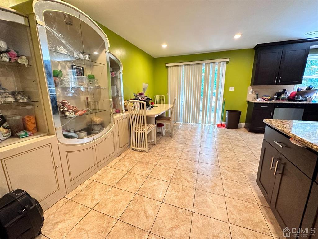 1722 Holly Road North Brunswick, NJ 08902 - Photo 6 of 22 a kitchen with stainless steel appliances kitchen island granite countertop a sink and cabinets
