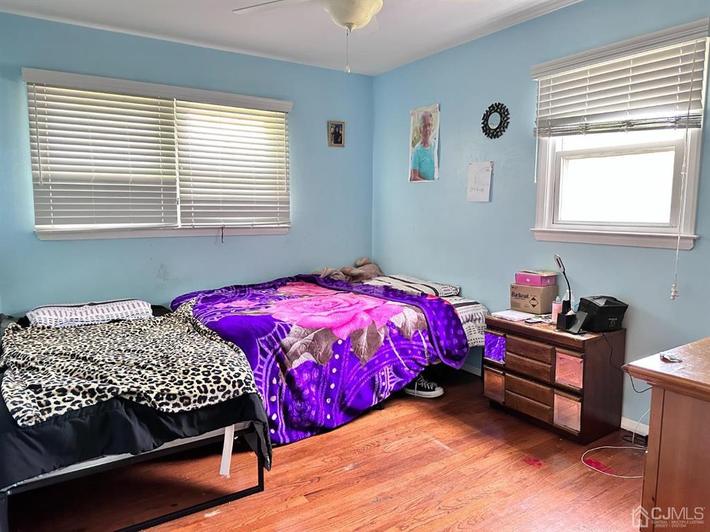 1722 Holly Road North Brunswick, NJ 08902 - Photo 8 of 22 a bedroom with a bed and a window