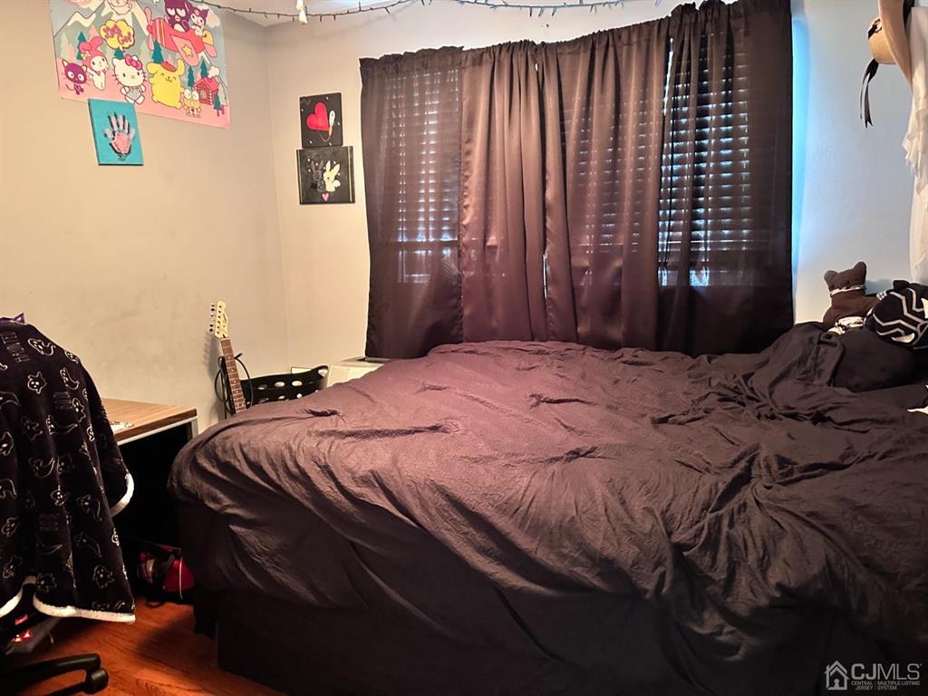 1722 Holly Road North Brunswick, NJ 08902 - Photo 9 of 22 a bedroom with a bed and a cabinets