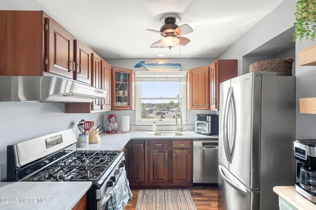 a kitchen with stainless steel appliances a stove a refrigerator and a sink
