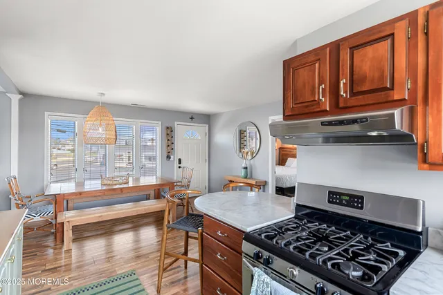 a kitchen with a stove a sink and a cabinets