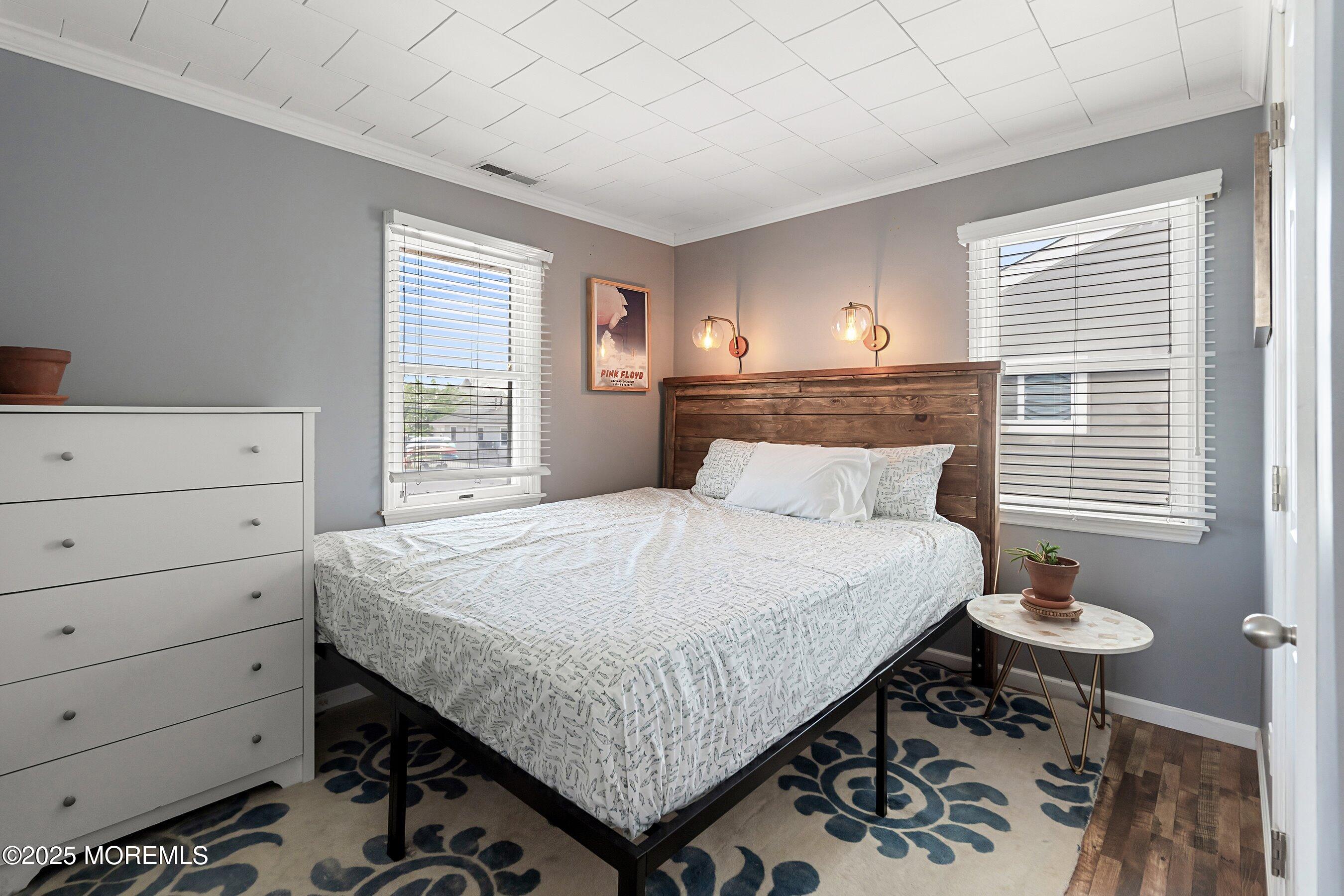 167 4th Avenue Manasquan, NJ 08736 - Photo 17 of 54 a bedroom with a bed and a dresser