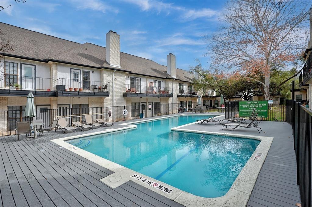 1307 Kinney Avenue, Unit 121 Austin, TX 78704 - Photo 12 of 12 a view of a house with pool fire pit couches with wooden floor
