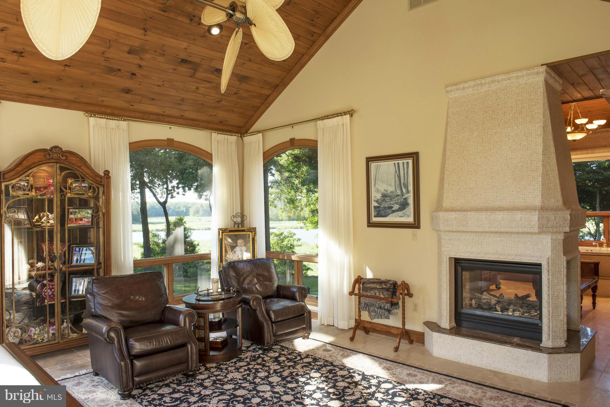 1822 Hatfield Road Huntingtown, MD 20639 - Photo 19 of 27 a living room with furniture a flat screen tv and a fireplace