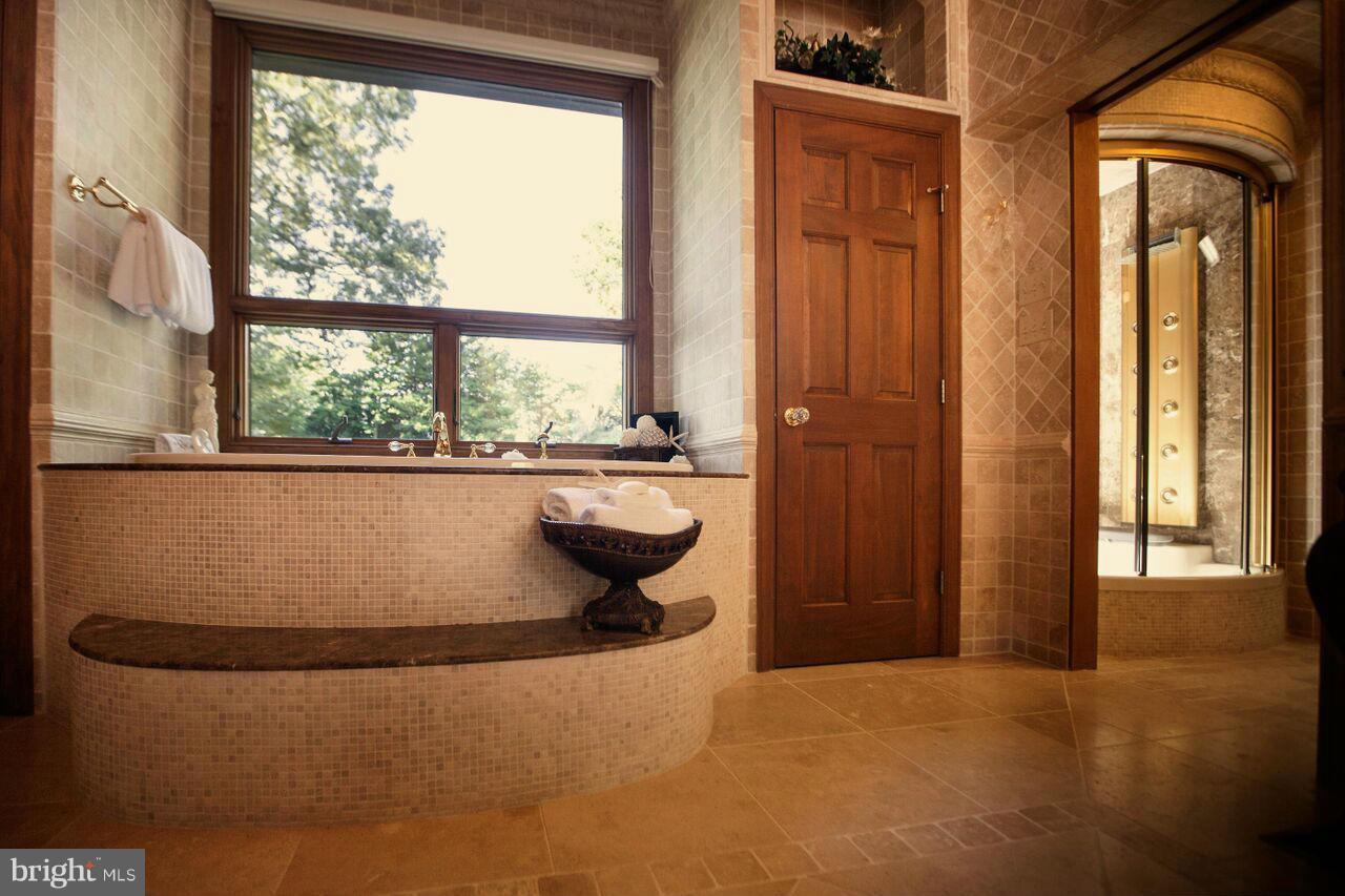 1822 Hatfield Road Huntingtown, MD 20639 - Photo 21 of 27 a view of a bath tub sitting in a bathroom next to a window