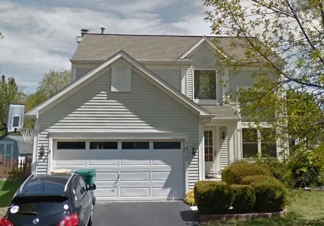 a view of a house with a yard