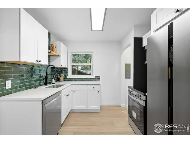 a kitchen with stainless steel appliances a refrigerator sink and cabinets