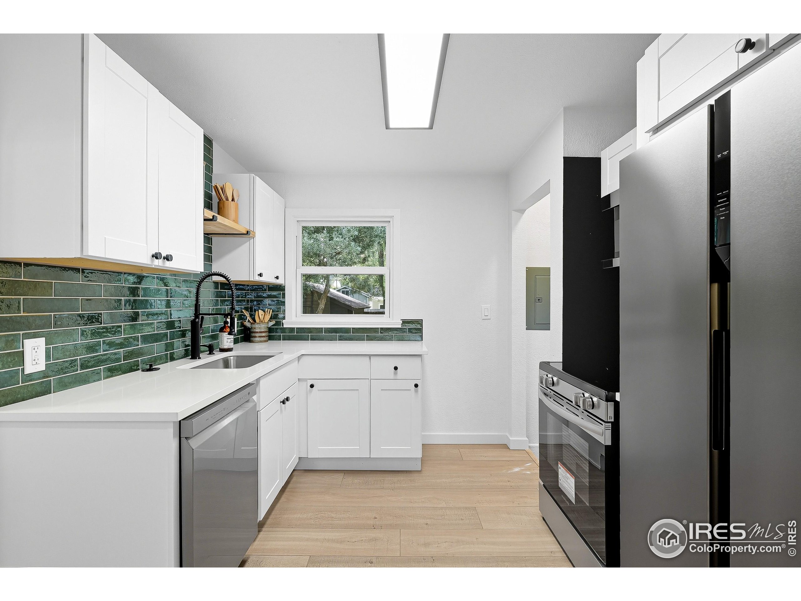 200 Bishop Street Fort Collins, CO 80521 - Photo 11 of 33 a kitchen with stainless steel appliances a refrigerator sink and cabinets