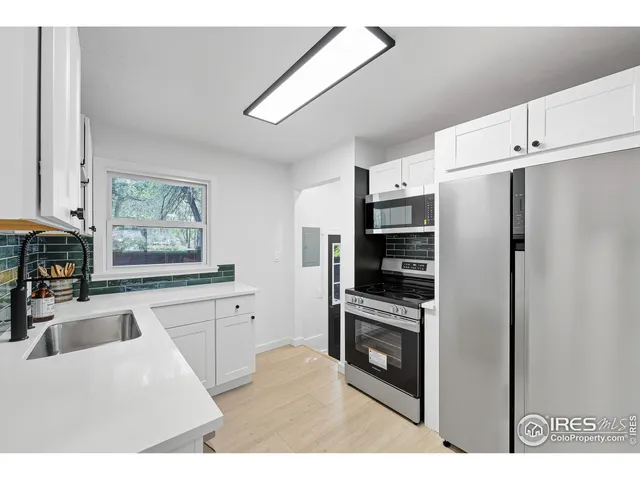a kitchen with stainless steel appliances a refrigerator sink and stove