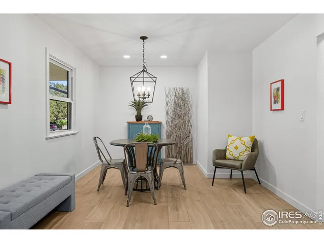 a view of a dining room with furniture wooden floor and chandelier
