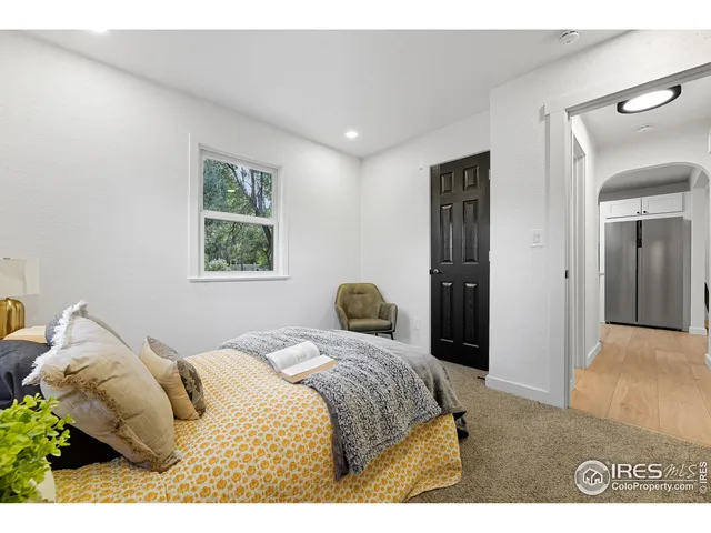 a bedroom with a bed and a painting on the wall