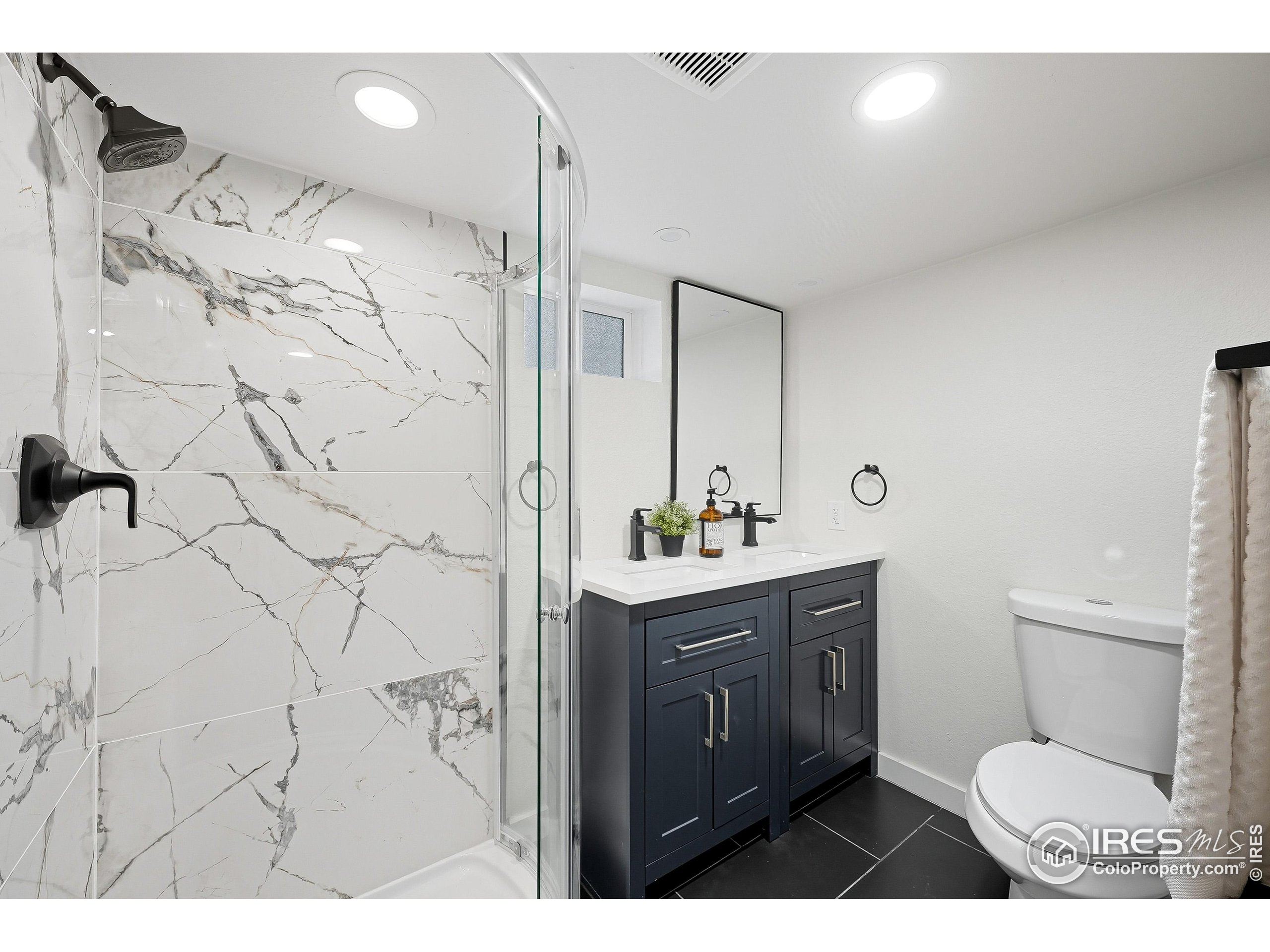 200 Bishop Street Fort Collins, CO 80521 - Photo 20 of 33 a bathroom with a granite countertop sink toilet a mirror and shower