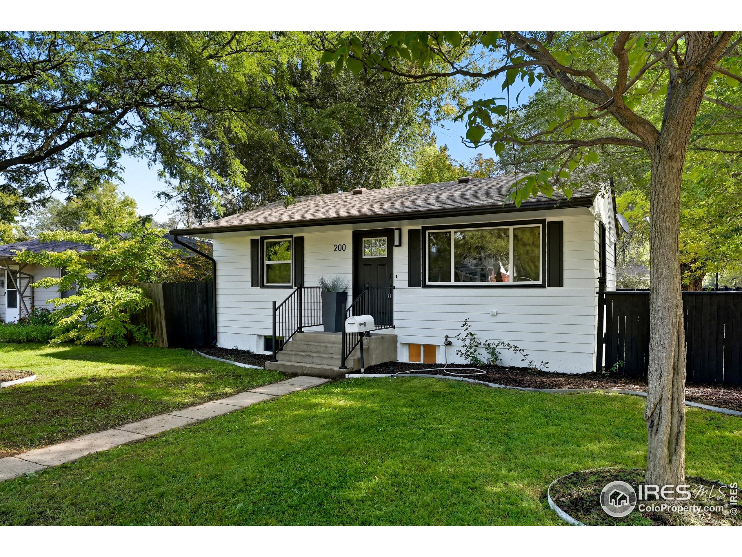 200 Bishop Street Fort Collins, CO 80521 - Photo 2 of 33 a view of a backyard with table and chairs and large tree