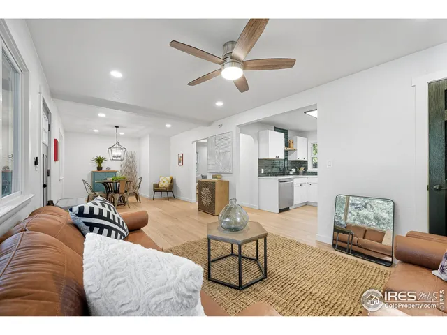 a living room with furniture and kitchen view