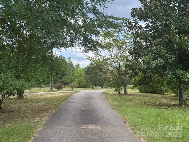a view of outdoor space with green field and trees