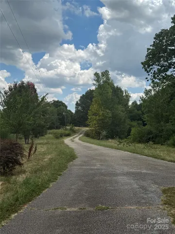 a view of a field with trees in background