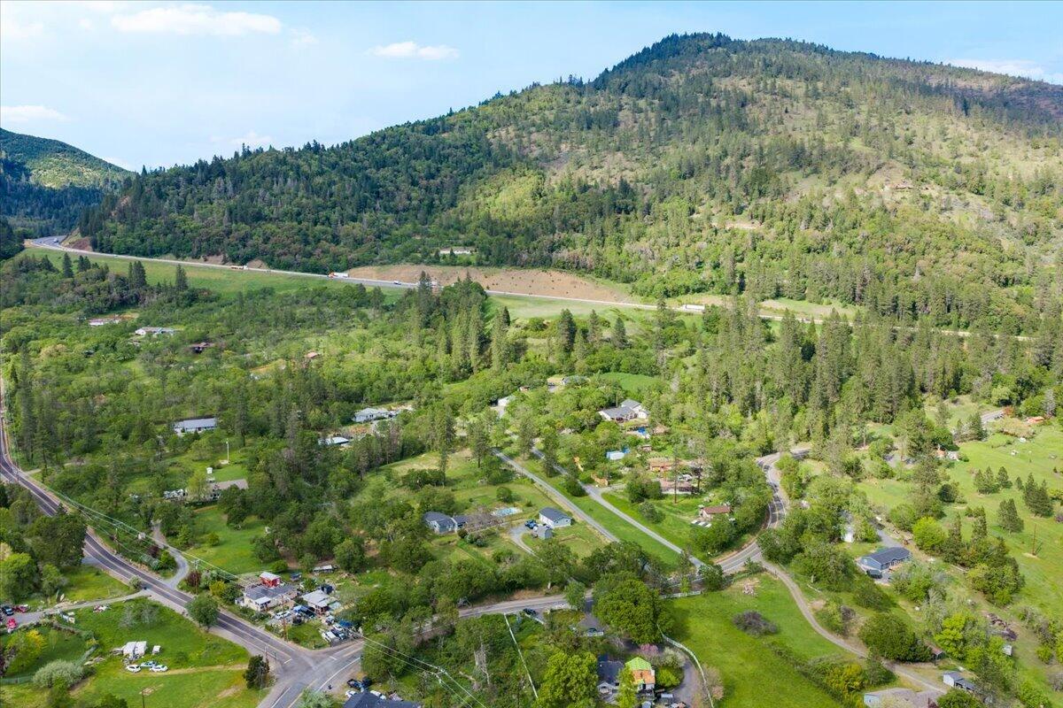 1360 Oxyoke Road Grants Pass, OR 97526 - Photo 35 of 39 a view of a lush green forest with houses